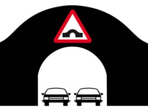 Two cars passing though arched bridge
